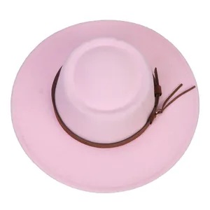 Top view of a light pink flat-top fedora hat with a brown leather strap and tassels