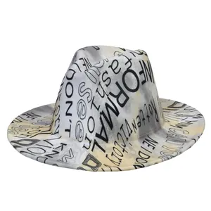 Detail of fedora hat featuring graffiti prints and yellow tie-dye patterns on white fabric