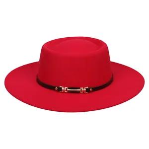Detailed close-up of a red flat-top jazz hat featuring a black band with a gold buckle