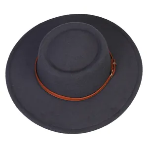 Detail of dark grey wide brim wool fedora with brown leather band and gold buckle