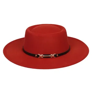 Detailed close-up of a red wool felt boater hat with black leather band and gold buckle