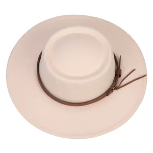 Top view of cream felt fedora hat featuring flat brim and brown leather band detail