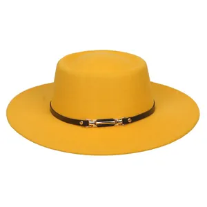 Detail of bright yellow flat top wool felt hat with black band and gold buckle