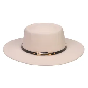 Close-up of beige flat top wool fedora featuring a slim black leather band and gold buckle