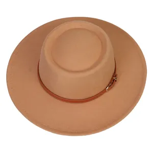 Detail of camel felt fedora hat featuring a brown leather band and gold buckle