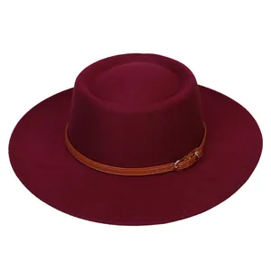 Detail of wine red wide brim fedora with brown leather strap and metal buckle