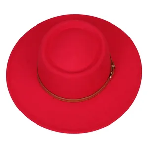 Close-up of vibrant red felt fedora with a brown leather band and gold metal buckle