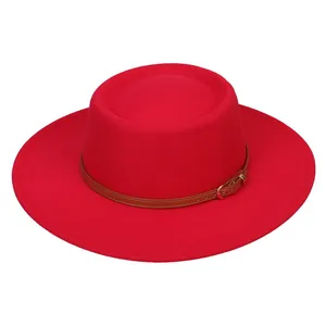 Detail of red wool felt fedora featuring a brown leather decorative band with metal buckle