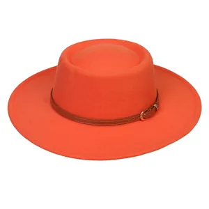Detail of orange wide brim felt fedora hat with brown leather band and gold buckle