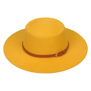 Close-up of vibrant yellow wool fedora featuring a slim brown leather band and gold buckle