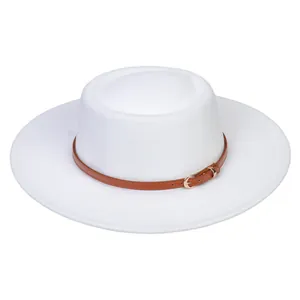 Detail view of white flat top fedora with brown leather buckle strap accent
