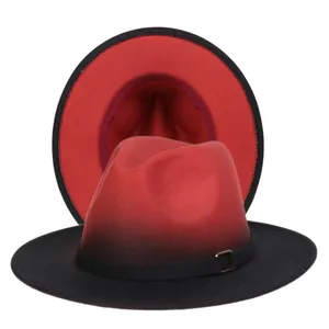 Close-up of red and black gradient wool fedora hat with metal buckle band detail