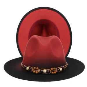 Detailed macro view of a red and black gradient fedora hat with ethnic beaded band decoration