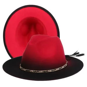 Close-up of red and black gradient wool fedora with gold chain and black tassel