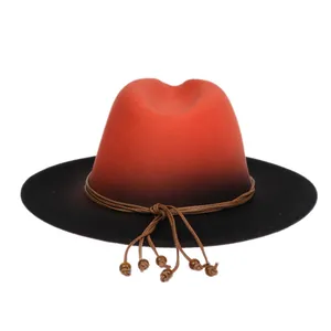 Detail of wide brim fedora hat featuring orange-black gradient felt and beaded cord