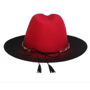 Detail of red and black gradient fedora hat with gold chain and tassel bow decoration