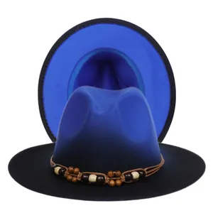 Close-up of fedora hats featuring gradient blue and black felt with beaded woven band