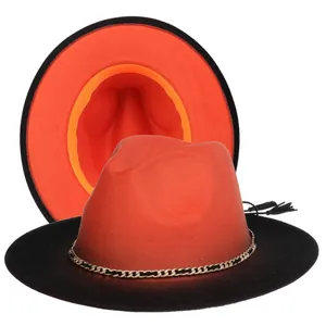 Detail of two-tone wool fedora with gold chain trim and black tassel decoration
