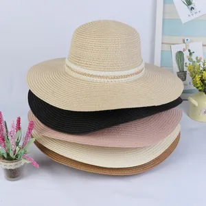 Detail of multi-color wide brim straw hats with elegant pearl and gold chain decorations