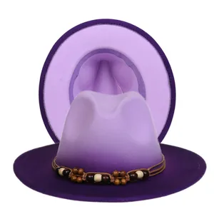 Detailed shot of gradient purple fedora with wooden bead trim and wide brim design