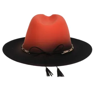 Detail of red and black gradient wool fedora hat with gold chain and dual tassels