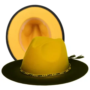Detail of yellow and black wool fedora featuring gold chain and tassel decoration