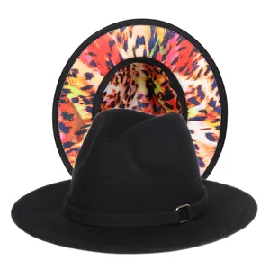 Detail of fedora hat showing classic black exterior and colorful leopard tie-dye lining
