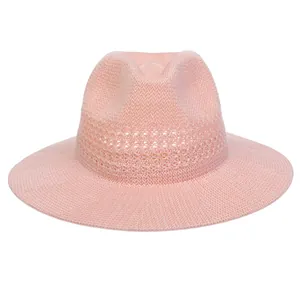 Close-up of a light pink woven Panama hat featuring breathable hollow knit detailing