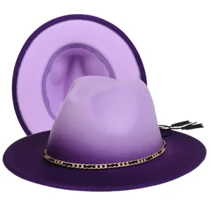 Detail of purple gradient fedora hat with gold chain band and black tassels on white base
