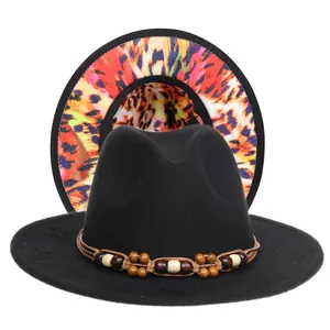 Detail of wool fedora hat with wooden beads band and colorful leopard print underbrim