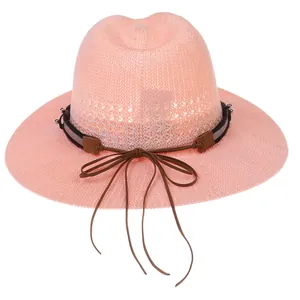 Elegant pink woven Panama straw hat with leather band and tassel detail for summer sun protection