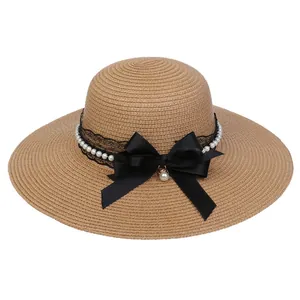 Elegant khaki wide brim straw hat with black lace ribbon and pearl bow accent