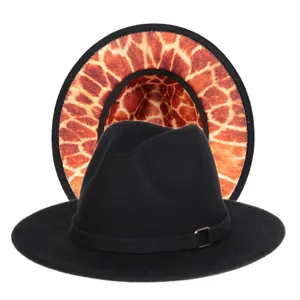 Detailed view of black fedora hat with unique giraffe print lining and gold buckle