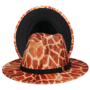 Detail view of colorful giraffe pattern fedora hat featuring black band and metal buckle
