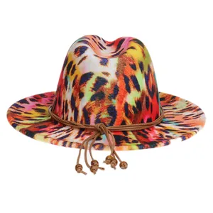 Detail view of multi-colored abstract print fedora hat with beaded tassel decoration