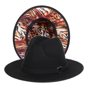 Detail of fedora hat with black wide brim and orange tiger print pattern under the brim