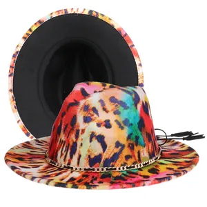 Detail of colorful leopard print fedora hat featuring gold chain and black tassel accent