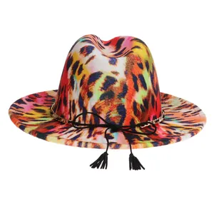 Detail of colorful leopard print fedora hat featuring gold chain and black tassel bow