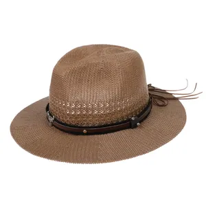 Detail of wide brim straw hat featuring leather band with metal bull head and fringes