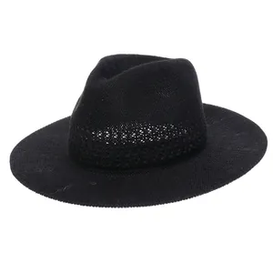 Detailed close-up of breathable mesh texture on a black summer straw fedora hat