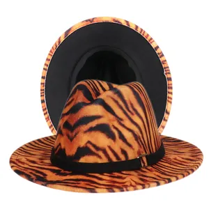 Macro shot of tiger print fedora with black ribbon trim and gold buckle detail