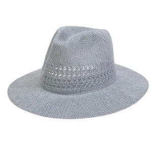Detailed close-up of gray-blue woven straw hat with hollow knit texture and breathable mesh band
