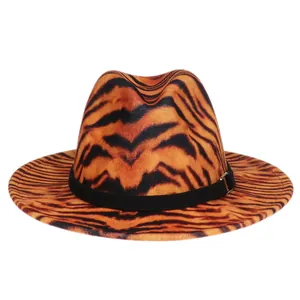 Detail of tiger print fedora hat featuring orange leopard pattern and gold buckle band