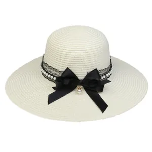 Wide brim straw sun hat for women with black lace ribbon and pearl bow accent