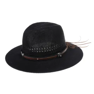 Macro detail of black vintage fedora hat with brown leather belt and metal studs decoration