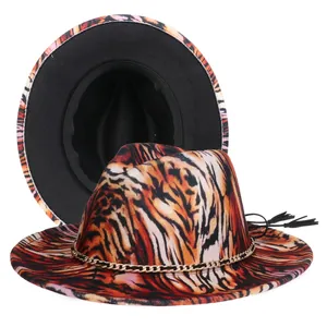 Close-up of tiger print wool fedora with gold chain and black tassel detail