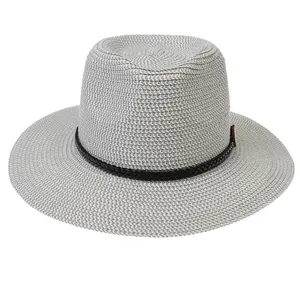Close-up of light grey straw fedora hat with fine woven texture and black ribbon band