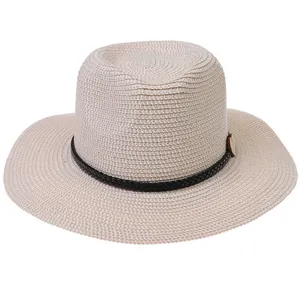 Detail of light beige straw fedora hat with black leather band and heart button