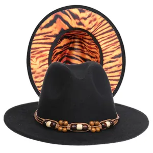Black fedora hat featuring tiger print underbrim and brown woven band with wooden beads