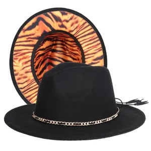 Detail of wide brim fedora with gold chain and orange tiger print lining
